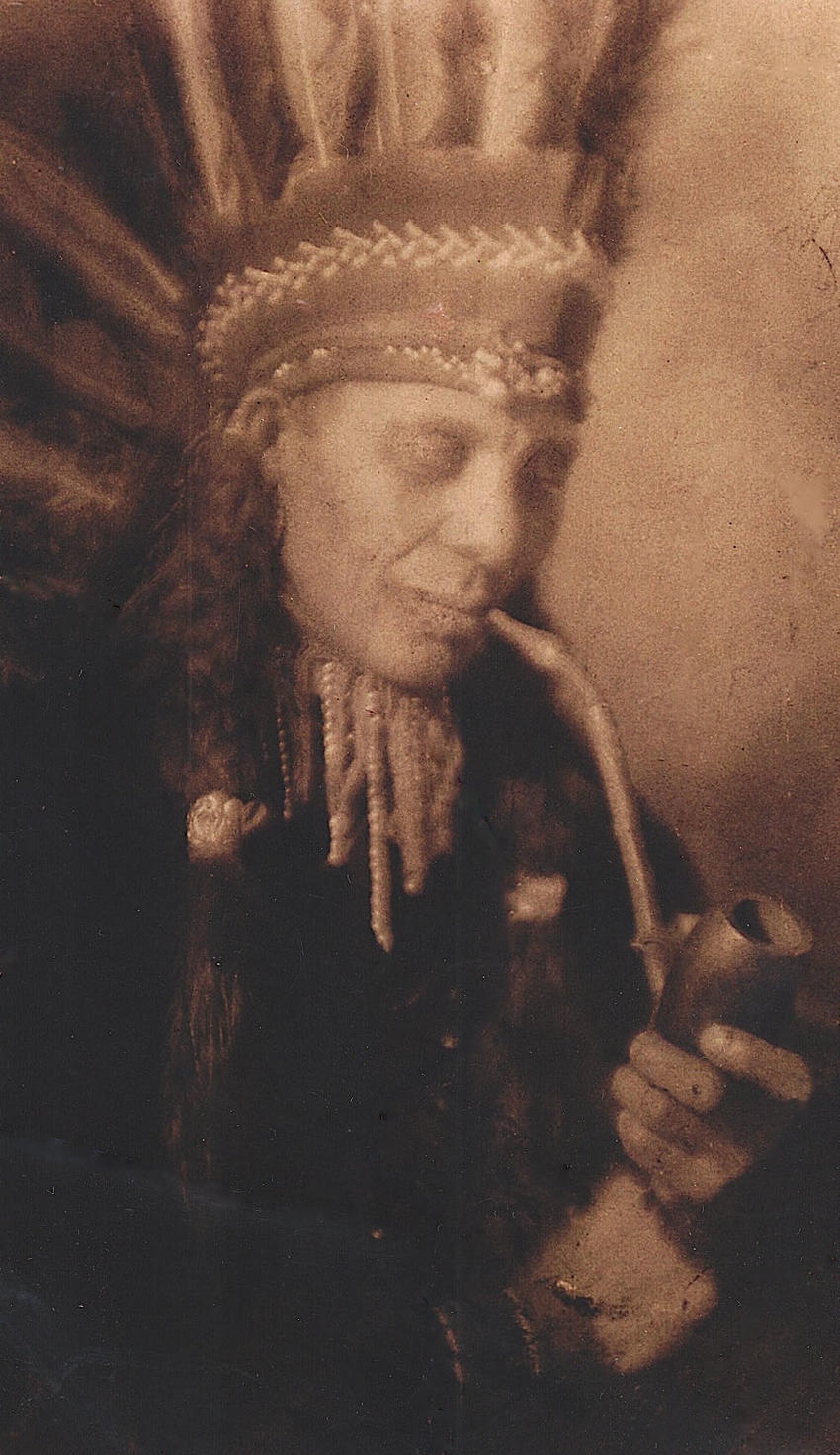 Ernest Jones with pipe and headdress