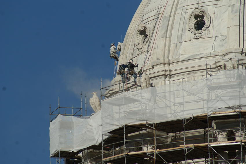 Workers cleaning and tuck pointing dome, 2011