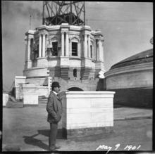 Cass Gilbert standing before a partially completed State Capitol Dome